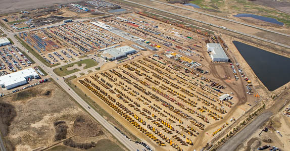 Ritchie Bros. Edmonton, AB auction site full of heavy equipment and trucks.