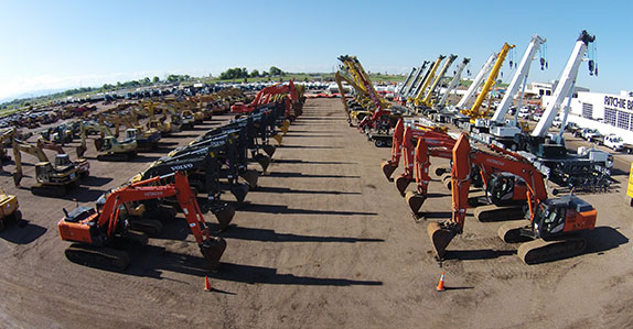 Rows of excavators at auction site