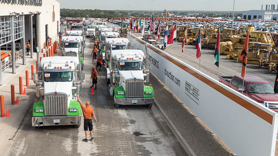 Truck tractors line up on the ramp at auction