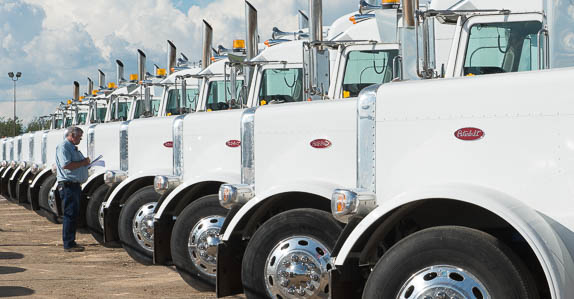 Inspecting used over the road Peterbilt trucks for sale at Ritchie Bros