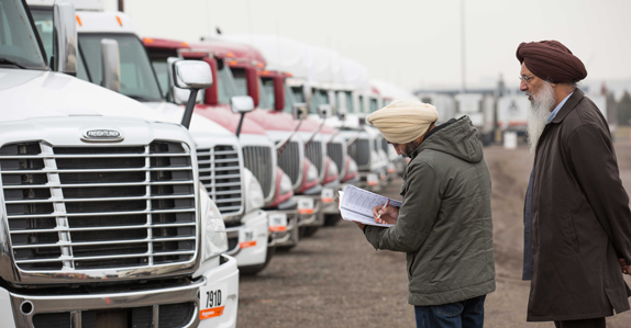 Potential buyers inspecting trucks at a Ritchie Bros. auction in Toronto