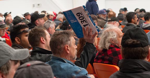A buyer places a bid on equipment at a Ritchie Bros. auction